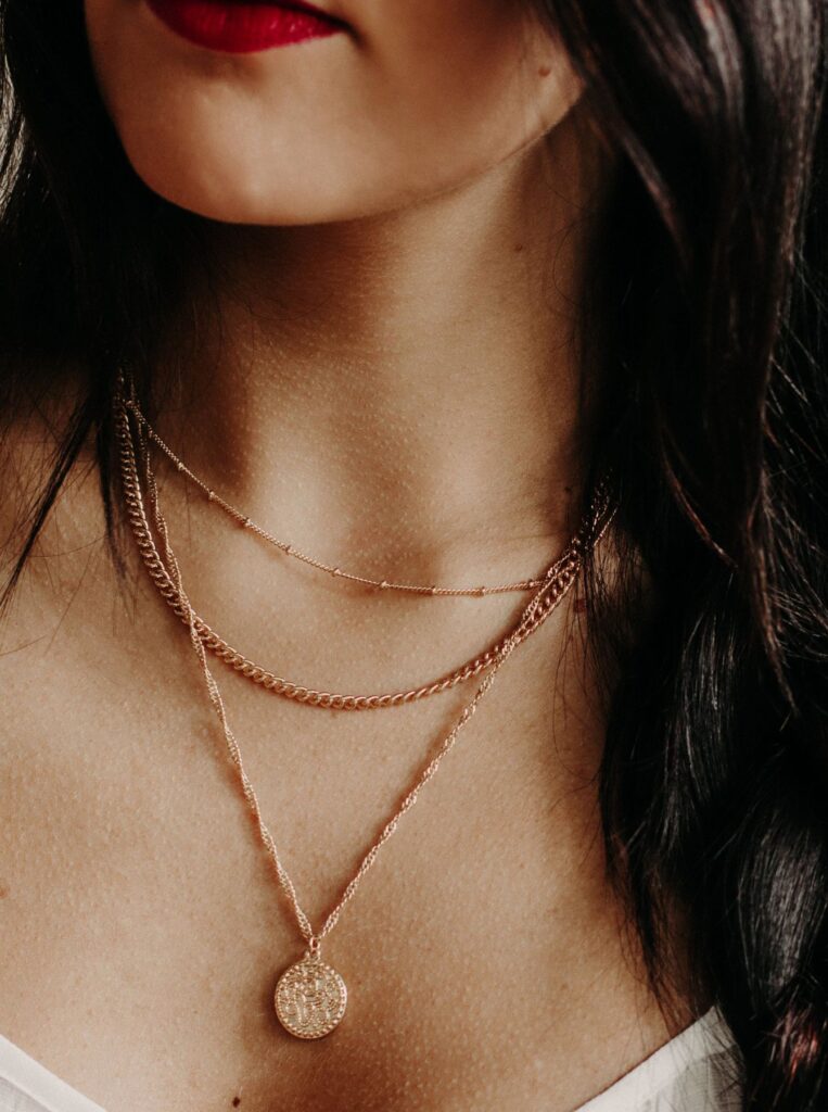 woman wearing a three layer necklace 