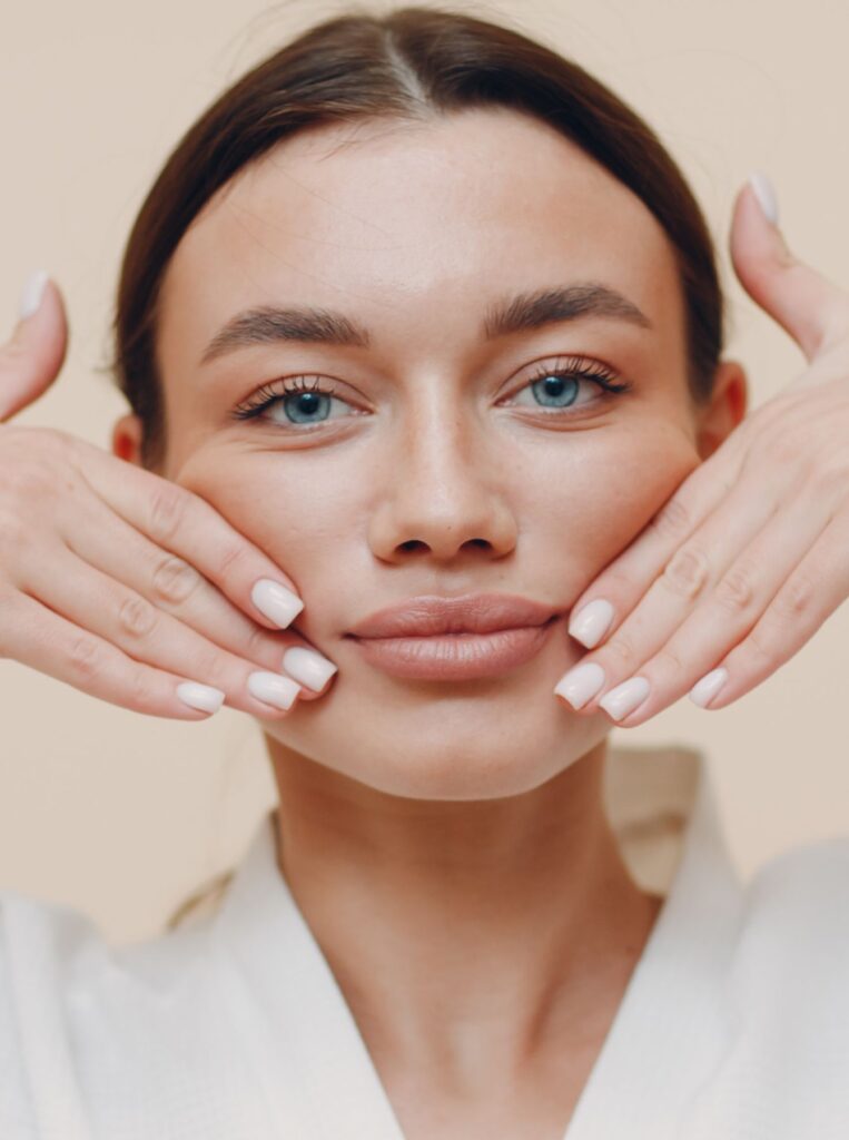 woman doing lip exercise to make her lips bigger