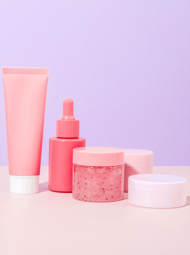 five skincare products with puprple background