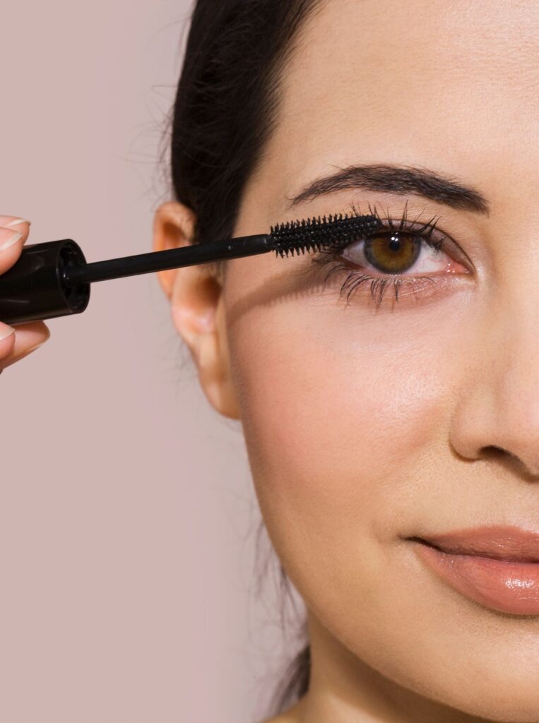 woman applying mascara